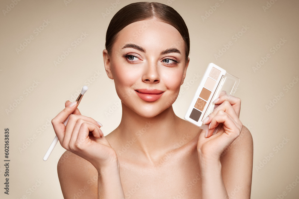 Naklejka premium Beauty woman with eye shadow makeup palette. Model with healthy perfect skin, close up portrait. Cosmetology, beauty and spa