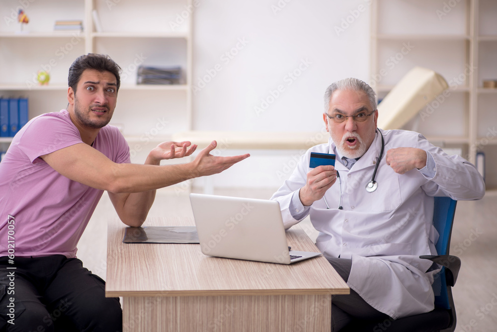 Obraz premium Young male patient visiting old male doctor