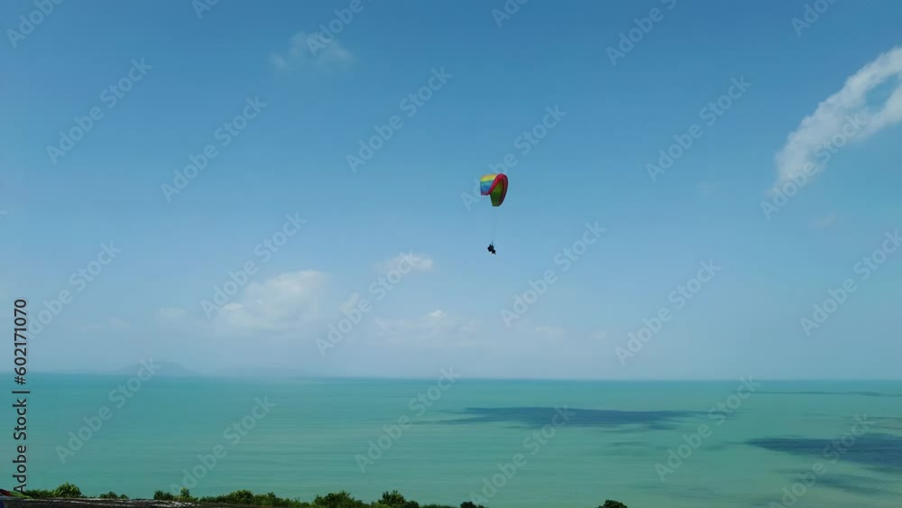 Paraglider flying above the sea. wind cone or wind sock blowing. 4k. Paraglider flying above the sea. wind cone or wind sock blowing. 4k.
