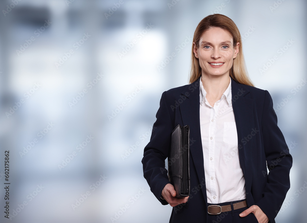 Beautiful real estate agent with leather portfolio in office, space for text Beautiful real estate agent with leather portfolio in office, space for text