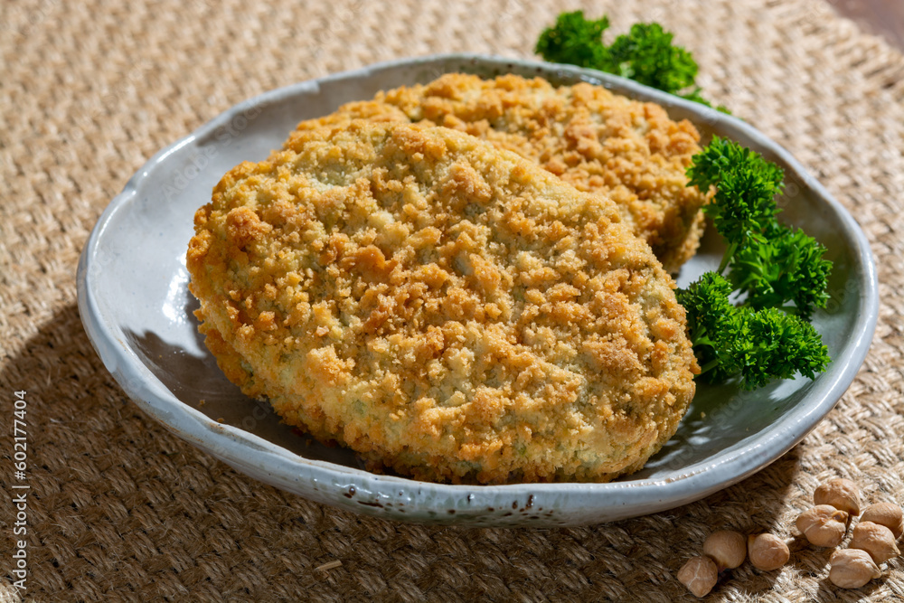 Uncooked fresh vegan and vegetarian burgers made from fresh vegetables and dried legumes and beans, ready to barbecue grill Uncooked fresh vegan and vegetarian burgers made from fresh vegetables and dried legumes and beans, ready to barbecue grill