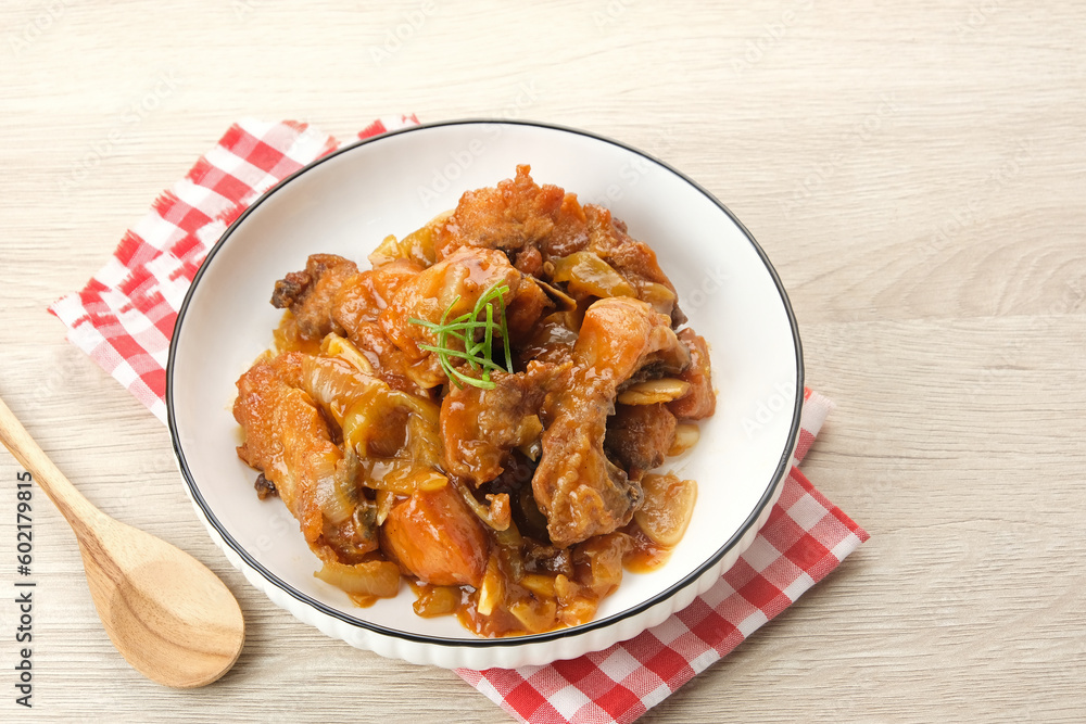 Ayam Goreng Mentega or Butter Chicken in white plate. Indonesian food.
Ayam Goreng Mentega or Butter Chicken in white plate. Indonesian food.
