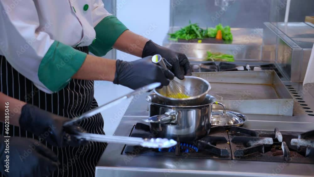 Closeup hand of young asian chef man beat egg for preparing cooking food in kitchen, nutrition and health, culinary and recipe, cuisine and lifestyles concept. Closeup hand of young asian chef man beat egg for preparing cooking food in kitchen, nutrition and health, culinary and recipe, cuisine and lifestyles concept.