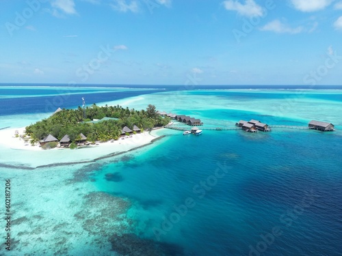 An idyllic paradise: a stunning aerial view of an island surrounded by crystal clear blue waters