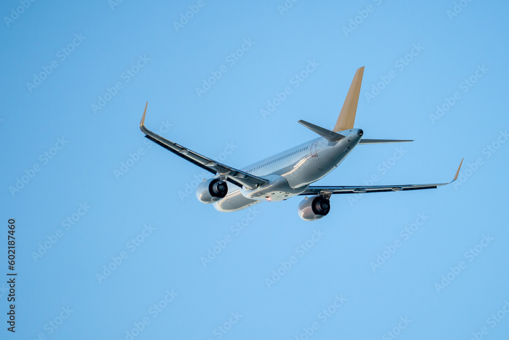 Passenger airplane flight in blue sky bottom view. Airplane fly high in clear sky. Travel concept. Passenger airplane flight in blue sky bottom view. Airplane fly high in clear sky. Travel concept.