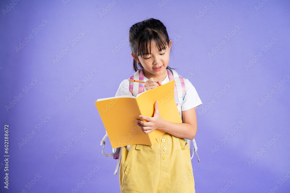 Obraz premium cute asian schoolgirl posing on purple background