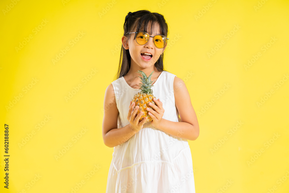 happy smiling asian baby girl on yellow background