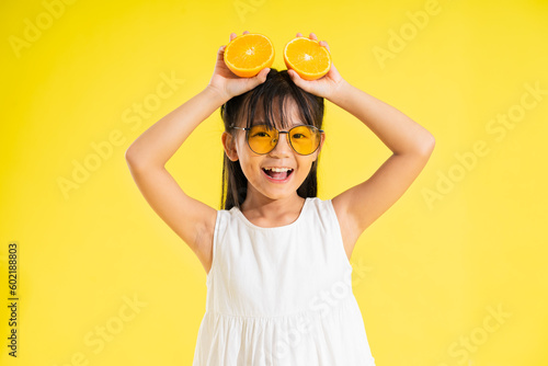 Wallpaper Mural happy smiling asian baby girl on yellow background Torontodigital.ca