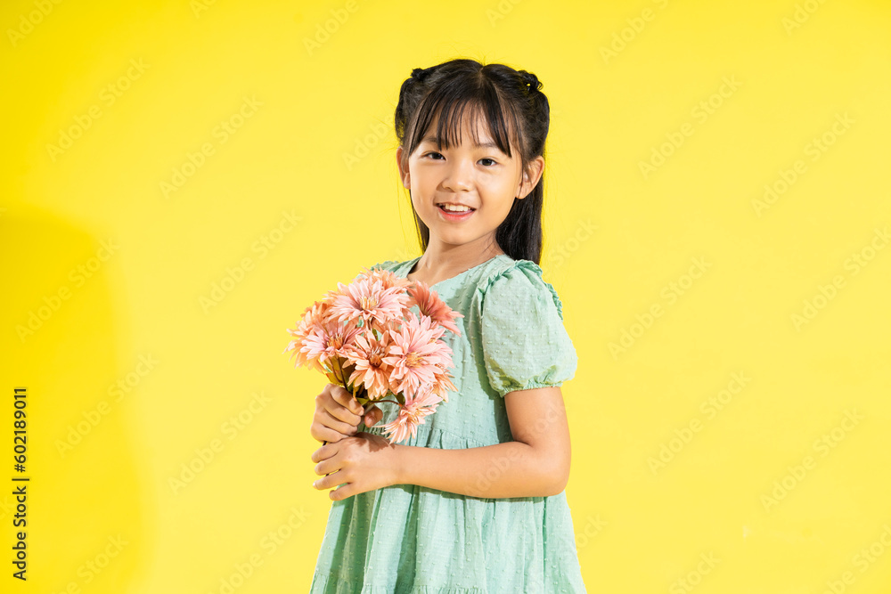 happy smiling asian girl on yellow background happy smiling asian girl on yellow background