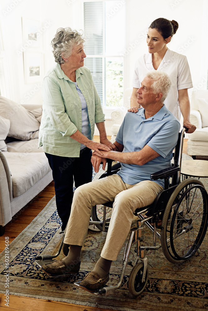 Support, old man in wheelchair with wife and nurse at nursing home for help with disability and rehabilitation. Healthcare, disability and senior couple with caregiver in living room for elderly care Support, old man in wheelchair with wife and nurse at nursing home for help with disability and rehabilitation. Healthcare, disability and senior couple with caregiver in living room for elderly care
