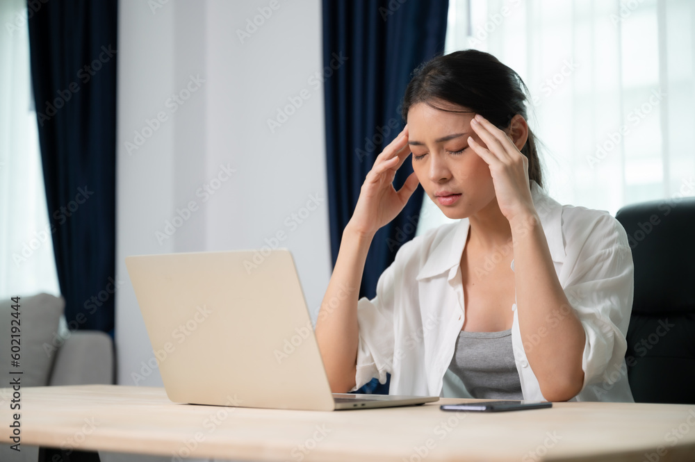 Office syndrome. Overworked tired young asian woman feeling headache, having eyesight problem after computer laptop work. Stressed young woman suffering from fatigue at home Office syndrome. Overworked tired young asian woman feeling headache, having eyesight problem after computer laptop work. Stressed young woman suffering from fatigue at home