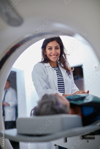 Doctor, mri and portrait of woman with patient to comfort in hospital for machine scanning. Ct scan, holding hands or smile of medical professional with senior person in radiology test for healthcare