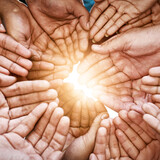 Closeup, hands and teamwork with collaboration, partnership and charity with sun flare. Group, people or volunteers with sunshine, friends and goals with help, hope and community with support or palm