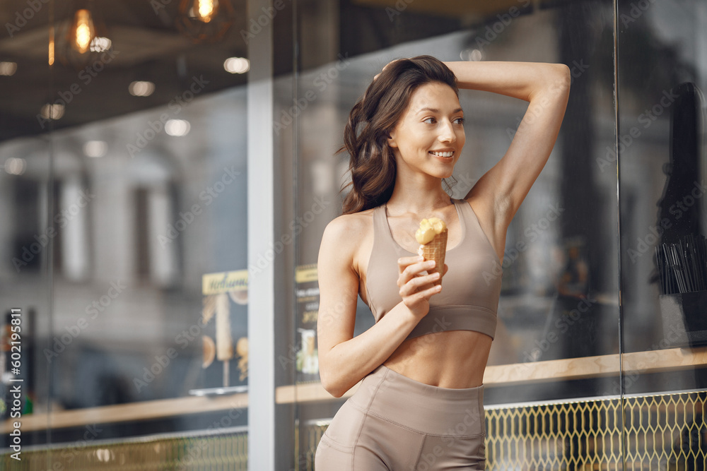 Woman standing in a summer city with ice cream