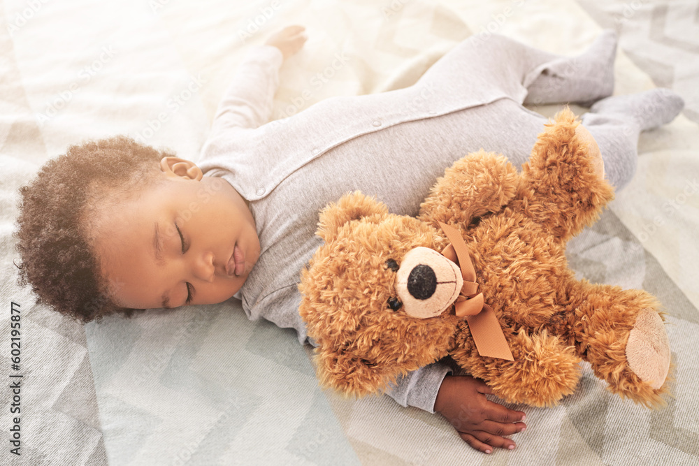 Sleeping, teddy bear and toy with baby in bedroom for carefree, development and innocence. Dreaming, relax and comfortable with african infant in nursery at home for morning, resting and bedtime