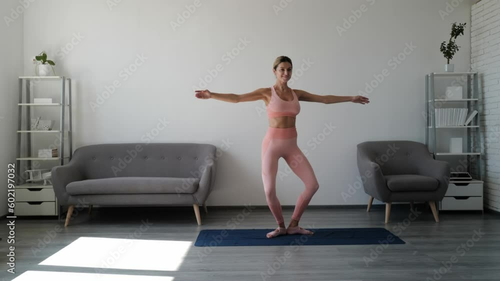 Fitness woman stretching indoor. Young woman doing stretching exercises. Sporty young woman doing exercise alone in living room. Workout at home for healthy body lifestyle concept. Fitness woman stretching indoor. Young woman doing stretching exercises. Sporty young woman doing exercise alone in living room. Workout at home for healthy body lifestyle concept.