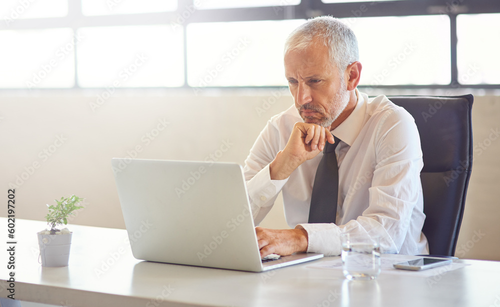 Laptop, thinking and strategy with a business man in the office, working online to finish a project at his desk. Computer, idea and email with a mature male manager at work for company research Laptop, thinking and strategy with a business man in the office, working online to finish a project at his desk. Computer, idea and email with a mature male manager at work for company research