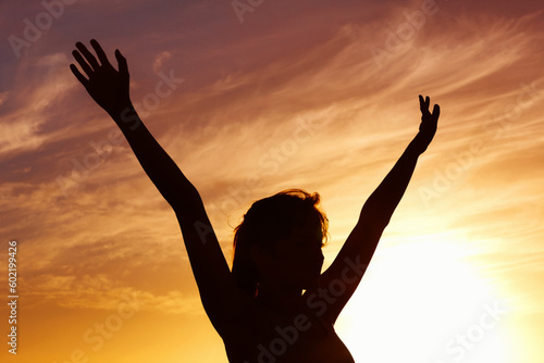 Silhouette, sunset and woman open arms and freedom outdoor, orange sky with fresh air and celebrate life. Meditation, wellness and peace in nature with shadow, female person with healthy mindset