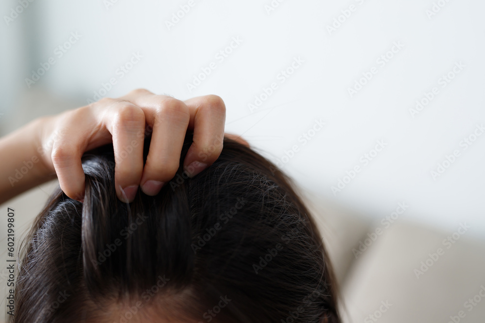 Naklejka premium A woman has problems with hair and scalp,she has dandruff from allergic reactions to shampoos. and hair conditioner