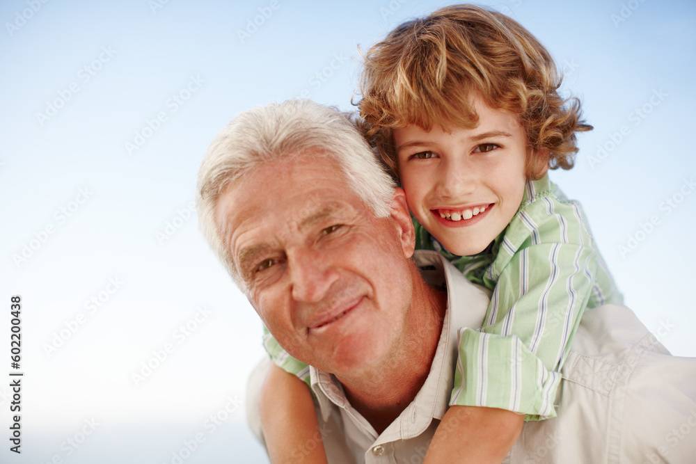 Piggyback, face of grandfather with child and happy outdoors in blue sky. Portrait of family love, quality time and cheerful grandparent with young boy outside in nature for freedom or summer holiday