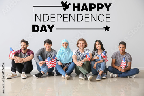 Group of people with USA flags sitting near light wall. Happy Independence Day