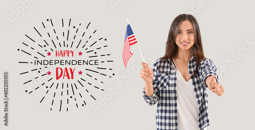 Young woman with USA flag and text HAPPY INDEPENDENCE DAY on light background