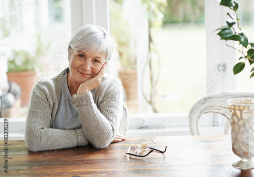 Portrait of senior woman, smile and relax in home for retirement and good mood. Face of happy elderly lady and person in house for happiness, confidence and wisdom of ageing, wrinkles or grey hair