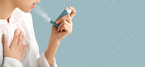Young woman using inhaler o...