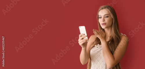 Young woman with mobile pho...