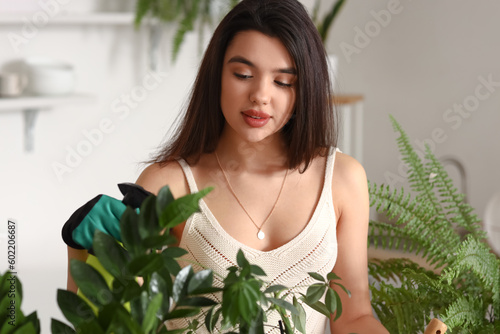 Young woman spraying water ...