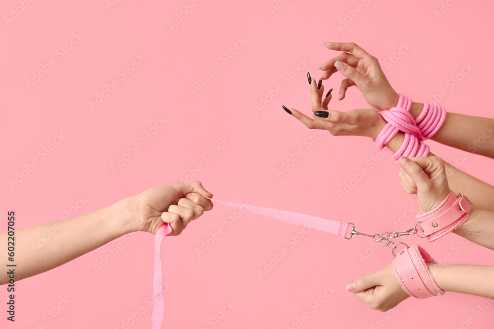 Women with sex toys on pink background - obrazy, fototapety, plakaty 