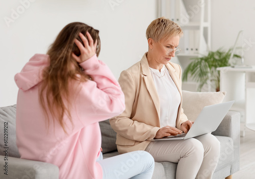 Mature psychologist working...