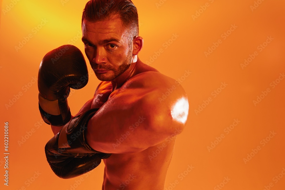 Man bodybuilder boxer muscle workout with naked torso. Advertising, sports, active lifestyle, colored yellow light, competition, challenge concept. 