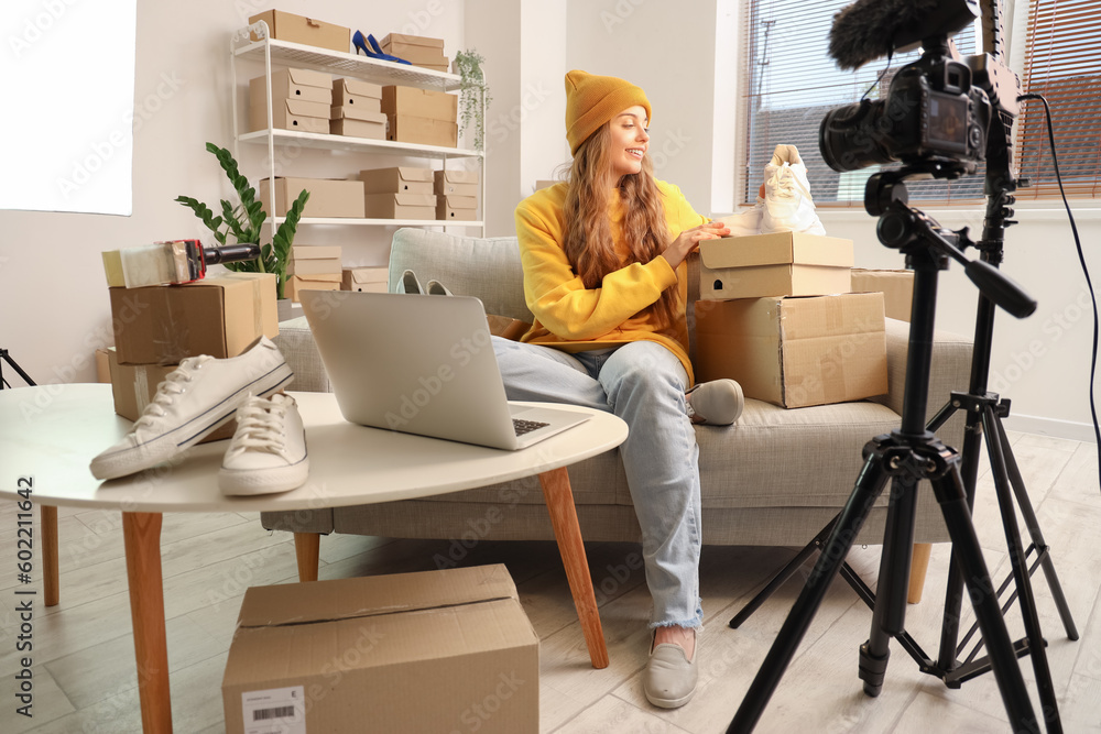 Female seller with shoes recording video at home Female seller with shoes recording video at home