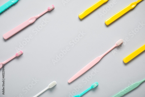 Plastic toothbrushes on grey background