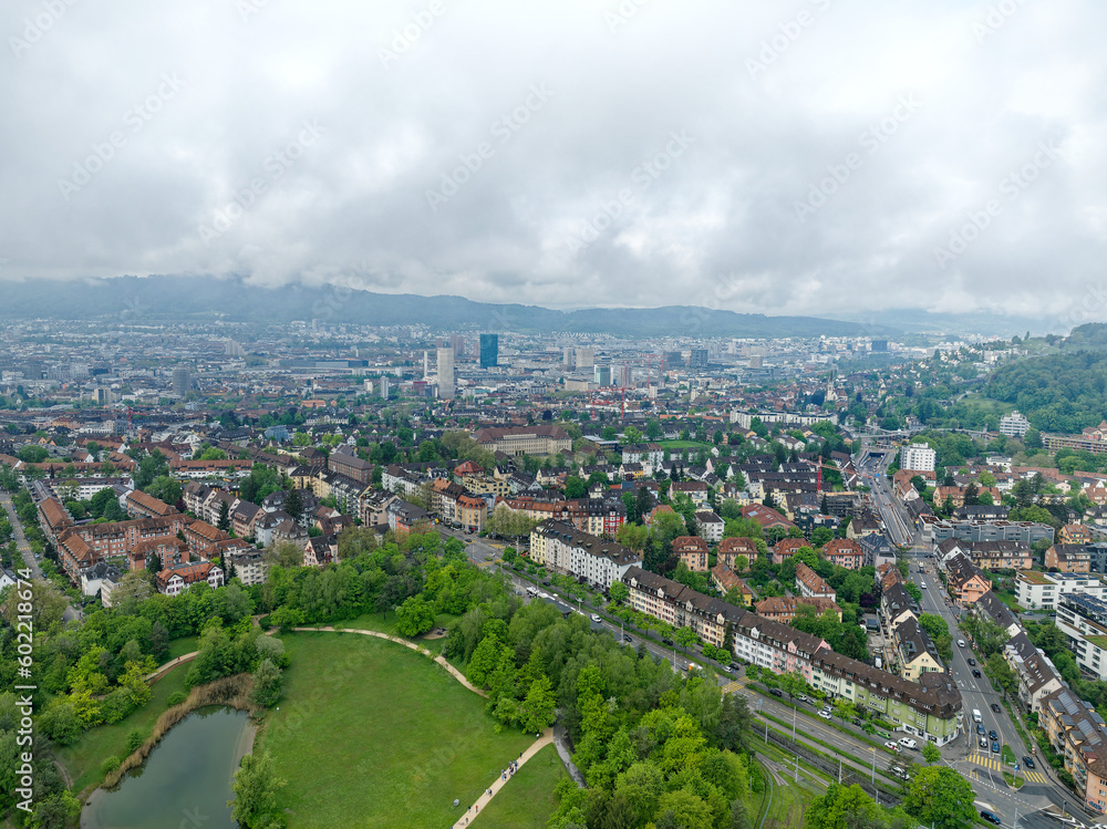 Obraz premium Aerial view of City of Zürich on a cloudy spring morning seen from public park named Irchel with cloudy sky background. Photo taken May 9th, 2023, Zurich, Switzerland.