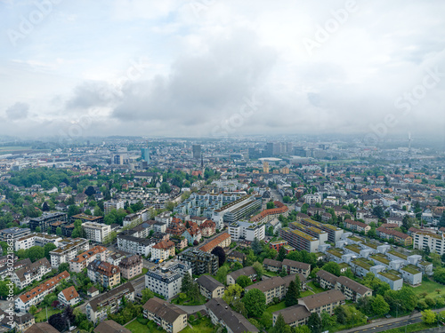 Aerial view of City of Zürich north on a cloudy spring morning seen from public park named Irchel with cloudy sky background. Photo taken May 9th, 2023, Zurich, Switzerland. photo