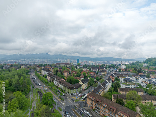 Aerial view of City of Zürich on a cloudy spring morning seen from public park named Irchel with cloudy sky background. Photo taken May 9th, 2023, Zurich, Switzerland.