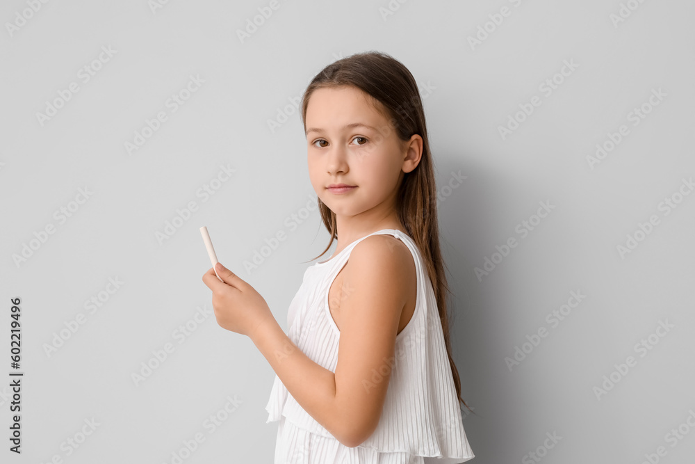 Little girl with chalk piece on light background. Children's Day celebration Little girl with chalk piece on light background. Children's Day celebration