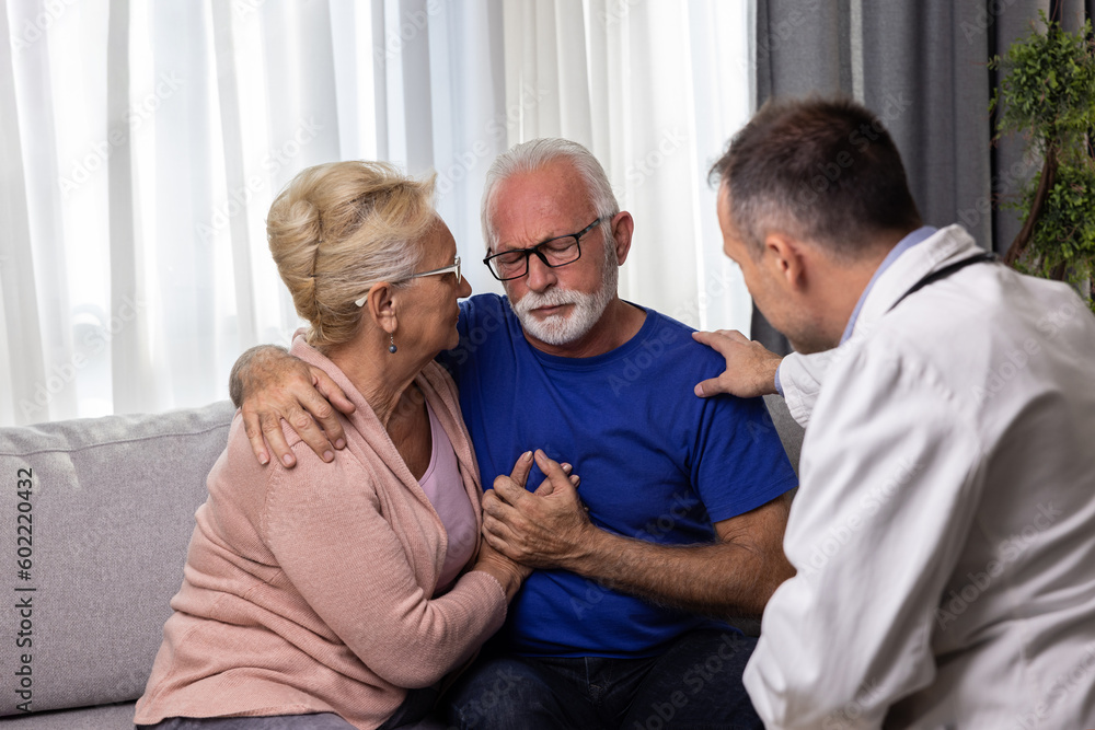 Fototapeta premium Distressed worried senior couple hugging after bad medical result while doctor is comforting them