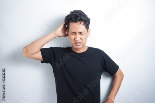 Young handsome man over isolated background suffering from headache desperate and stressed because pain and migraine. Hands on head.