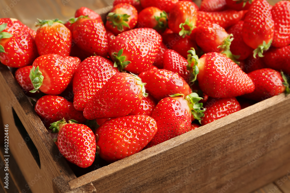 Wooden box with fresh strawberries as background