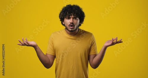 Frustrated indian man raising his hands and shrugging his shoulders with an indignant expression, asking the reason for the failure, showing disappointment, chagrin due to problems