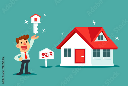 businessman with house key standing next to brand new house