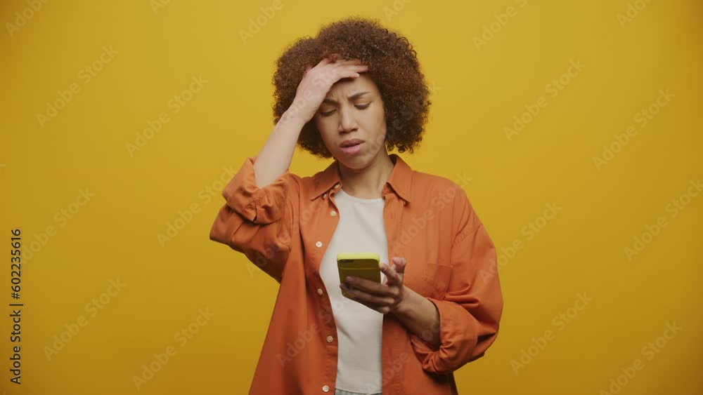 Woman Reading Bad News on Yellow Background, Sad Adult Female Woman Reading Bad News on Yellow Background, Sad Adult Female