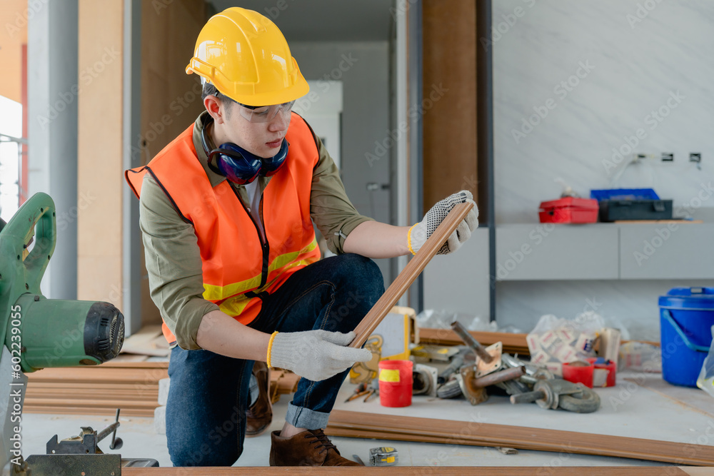 Structural worker dressed in safety gear and hard hat doing construction and using circular saw to work. Structural worker dressed in safety gear and hard hat doing construction and using circular saw to work.
