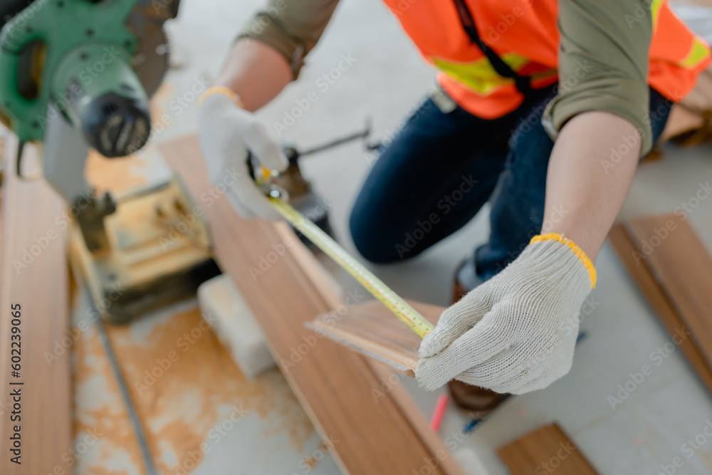 Structural worker dressed in safety gear and hard hat doing construction and using circular saw to work. Structural worker dressed in safety gear and hard hat doing construction and using circular saw to work.