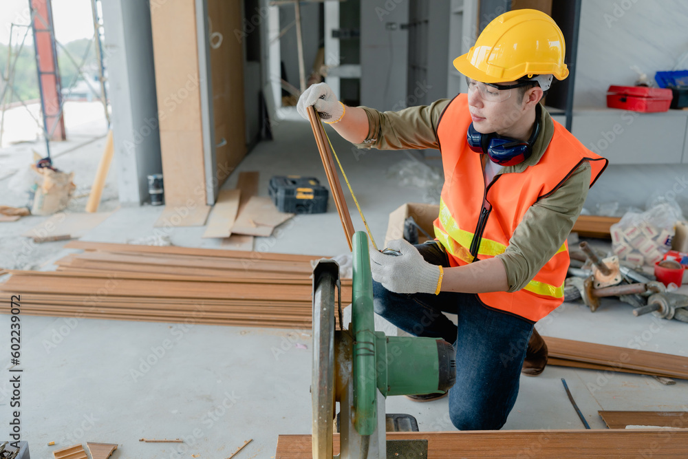 Structural worker dressed in safety gear and hard hat doing construction and using circular saw to work. Structural worker dressed in safety gear and hard hat doing construction and using circular saw to work.