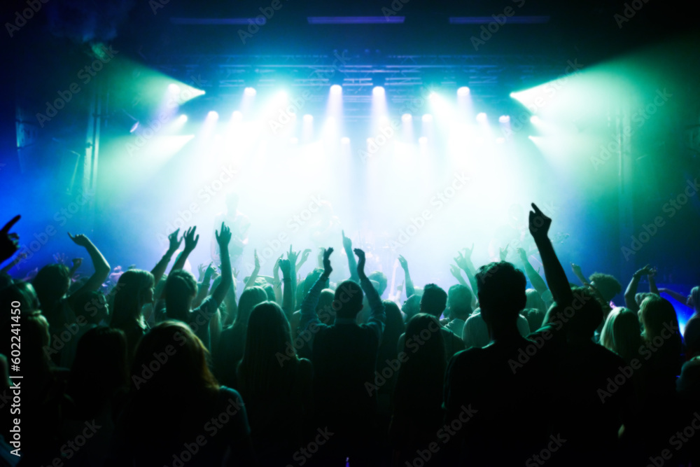Music, dance and party with crowd at concert for rock, live band performance and festival show. New year, celebration and disco with audience of fans listening to techno, rave and nightclub event