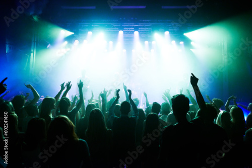 Fototapeta Naklejka Na Ścianę i Meble -  Music, dance and party with crowd at concert for rock, live band performance and festival show. New year, celebration and disco with audience of fans listening to techno, rave and nightclub event